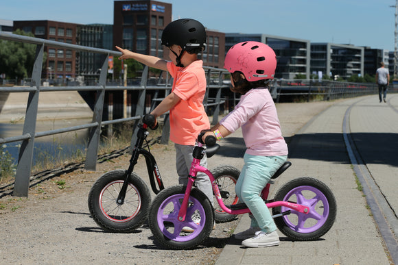 two children riding their puky bikes 